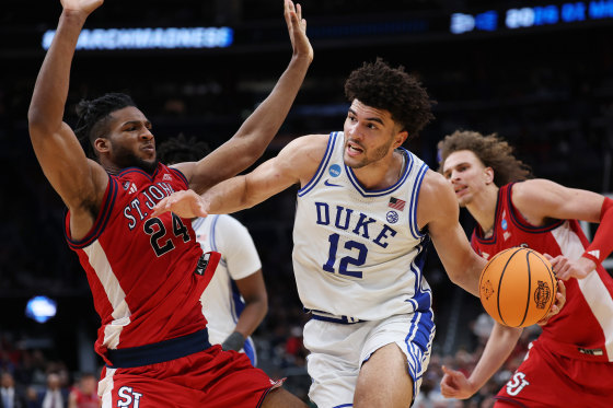 Duke star Cameron Boozer drives around Zuby Ejiofor of St. John's during the second half in the Sweet Sixteen.