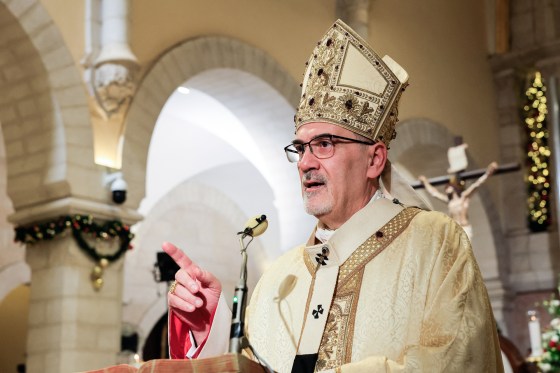 Pierbattista Pizzaballa speaks at an altar inside of a church
