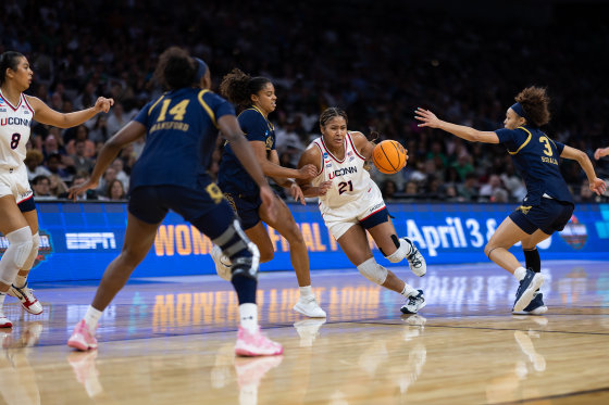 On-court action during an NCAA womens basketball game.