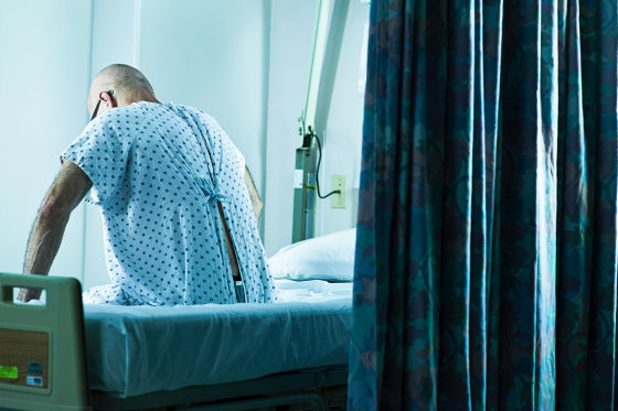 Senior man sitting on hospital bed