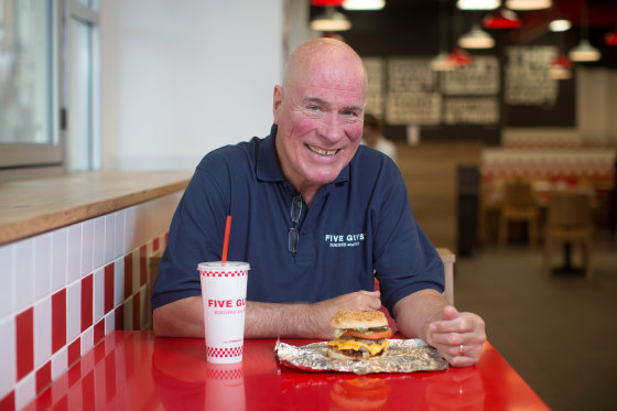 Jerry Murrell, founder of Five Guys, poses for a photograph inside the company's new hamburger outlet in London, U.K., on Tuesday, July 2, 2013.