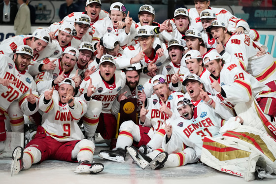 Denver players celebrate after defeating Wisconsin in the championship game at the NCAA Frozen Four men's college hockey tournament on Saturday.
