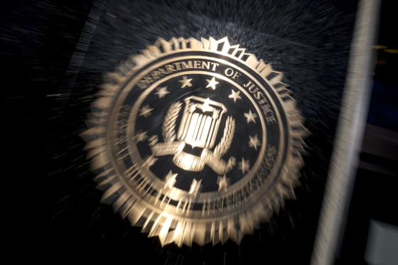 A blurred FBI sign on the exterior of a building.
