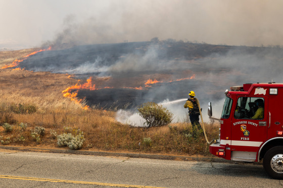 Firefighters battle the blaze at the site of the Springs Fire