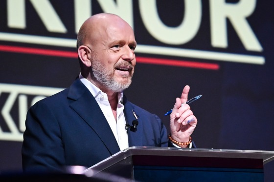 Steve Hilton speaks at a podium on stage