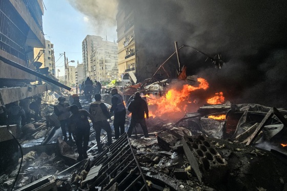 First responders stand amid rubble at the site of an Israeli airstrike in Beirut's Corniche al-Mazraa neighborhood on April 8, 2026. 