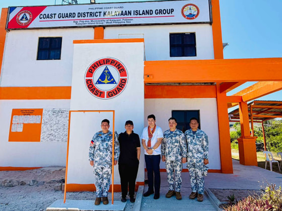 Senator Erwin Tulfo, center, poses with Philippine Coast Guard Admiral Ronnie Gil Gavan, second from right, on Thitu Island in the South China Sea