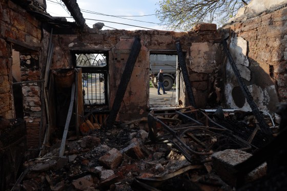 A local resident walks past a destroyed house following an air attack in Odesa on April 11.
