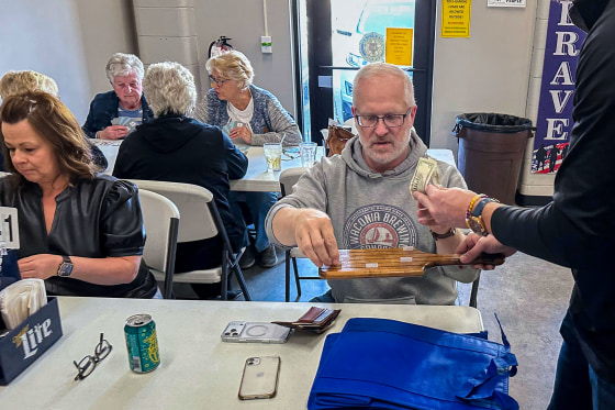 People buy tickets for the raffle.