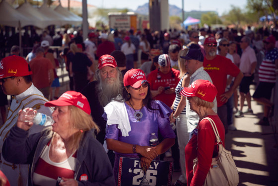 Guests wait in the entrance line for “Build the Red Wall” event headlined by President Donald Trump in Phoenix on Friday.