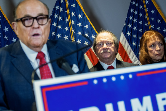 Joseph diGenova stands behind Rudy Giuliana during a press conference.