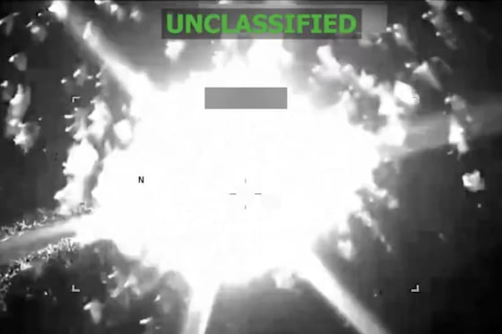 A grainy black-and-white surveillance image of an explosion that says UNCLASSIFIED across the top. 