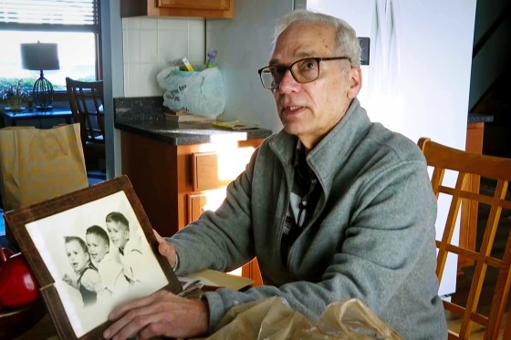 John Prevost, brother of Pope Leo XIV, holds a portrait of the three Prevost brothers from 1958, Pope Leo, 3, left, John, 4, and Louis, 7, at his home on May 8, 2025, in New Lenox, Ill.