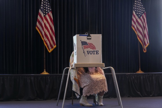 A voter works on her ballot at a polling place.