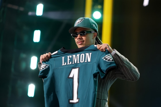 Makai Lemon holds up Philadelphia Eagles jersey 