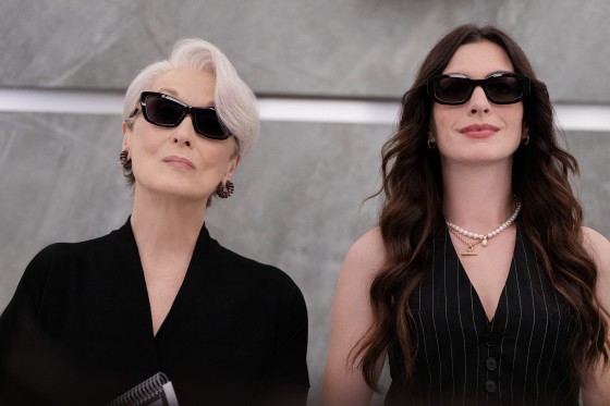 Meryl Streep and Anne Hathaway stand side by side wearing dark sunglasses.