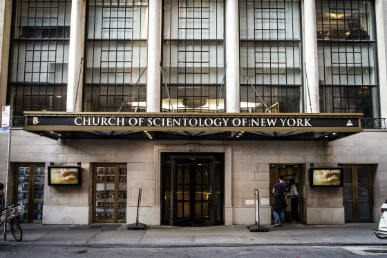 A brick building with tall windows and an awning with lettering: CHURCH OF SCIENTOLOGY OF NEW YORK.