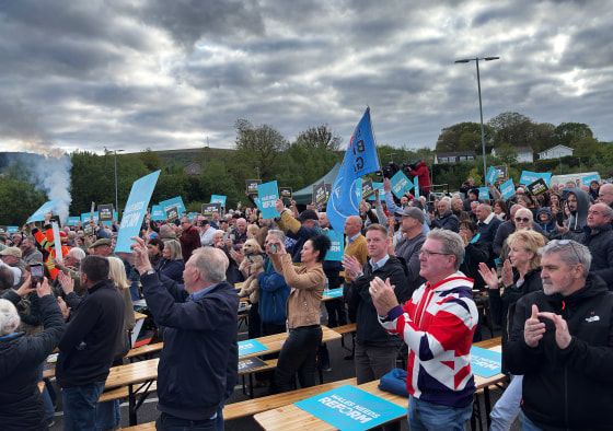 Crowds cheer Reform party leader Nigel Farage as he takes the stage at a rally in Merthyr Tidfil, Wales on Tuesday.