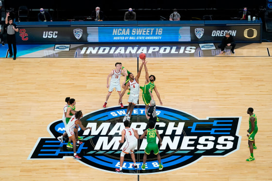 Southern California forward Evan Mobley fights for the opening tipoff with Oregon guard LJ Figueroa during a "March Madness" game in 2021.