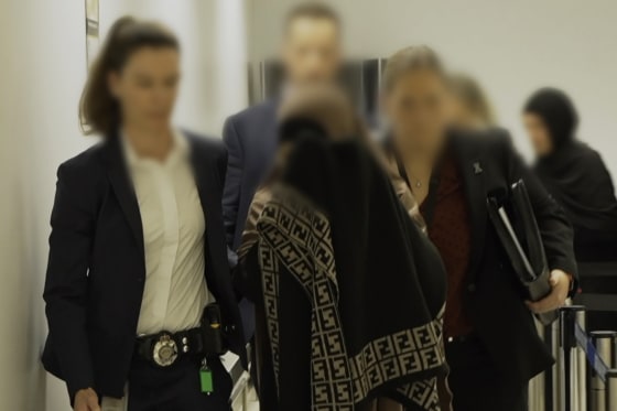 Two women, charged with crimes against humanity offences allegedly committed in Syria, are pictured after being arrested on arrival into Melbourne, Australia.