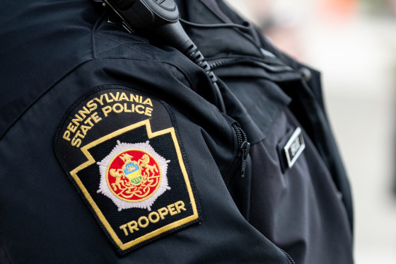A close up of a Pennsylvania State Police Trooper patch on the shoulder of an officer's uniform