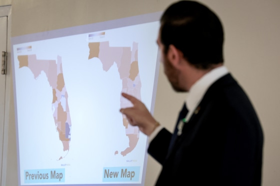 Oliver Larkin, Democratic candidate for Congress in Florida’s 23rd district, speaks during an emergency town hall that he held to address Florida Republicans’ newly approved congressional redistricting map (seen on wall).