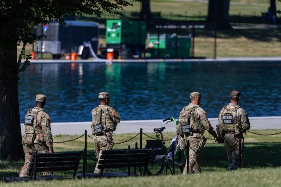 U.S. Army National Guard patrols as visitors walk along the Lincoln Memorial Reflecting Pool.