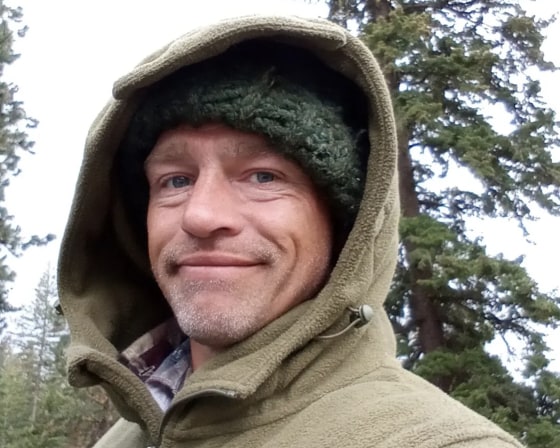 A selfie of Matt Brown with a knitted cap and a hood pulled up.