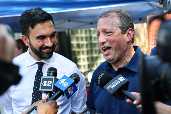 Zohran Mamdani, left, and Brad Lander speak into press microphones outside