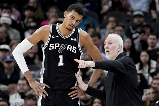 San Antonio Spurs head coach Gregg Popovich, right, talks with center Victor Wembanyama (1) during the first half of an NBA basketball game against the Los Angeles Lakers in San Antonio, Wednesday, Dec. 13, 2023.