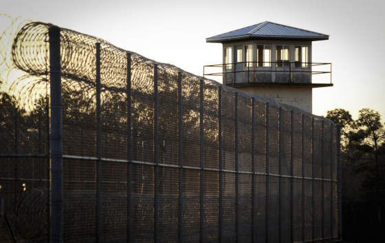 The sun sets behind Holman Correctional Facility in Atmore, Ala.