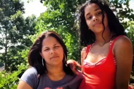 Emilia Ignacio, left, and her daughter Kiany DeJesus pose for a portrait outside in front of trees