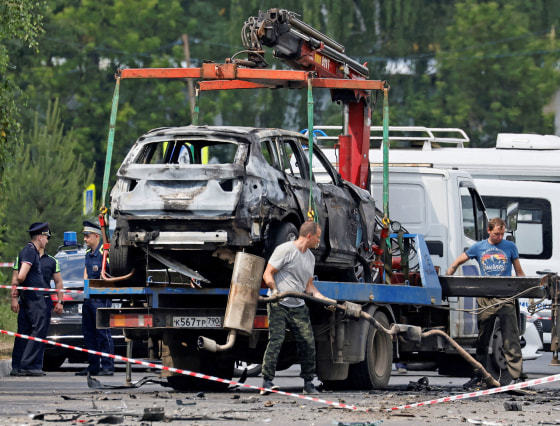 Investigators work at the scene of a car explosion in Balashikha