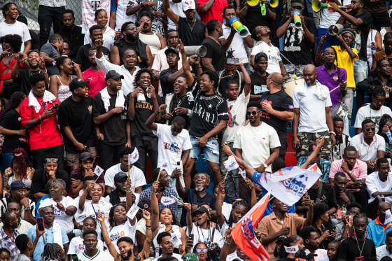 People react after a goal during a football match in Petion-ville, Port-au-Prince, Haiti, on April 12, 2026.