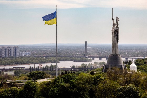The Ukrainian national flag flies near the Motherland monument at the National Museum of the History of Ukraine in the Second World War in Kyiv