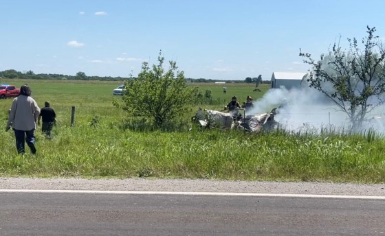Firefighters work on the site of an aircraft crash in Butler, Missouri