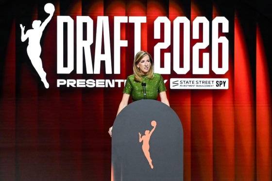 Cathy Engelbert speaks at a podium, behind her in large white text reads "Draft 2026"