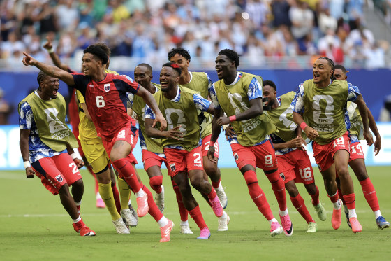 Cabo Verde players celebrate on the field during a world cup match.