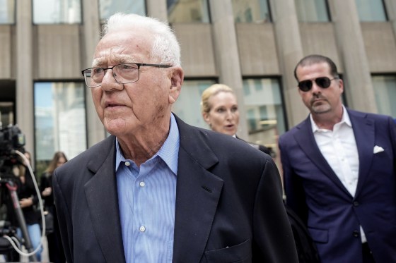 Frank stronach, outside a courthouse.