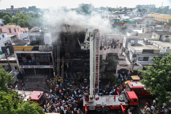 Firefighters try to douse a fire that broke out at a coaching institute.