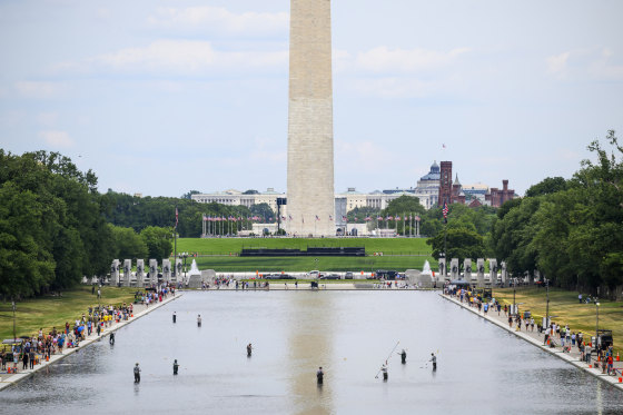 National Park Service personnel vacuum algae from the Reflecting Pool on June 21, 2026 in Washington.