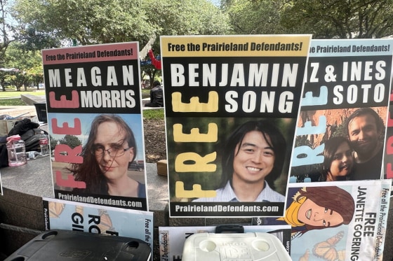 Posters with the faces of protesters accused by the Justice Department of having ties to antifa.