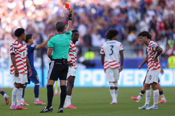 Referee Raphael Claus shows Folarin Balogun #20 of the United States a red card