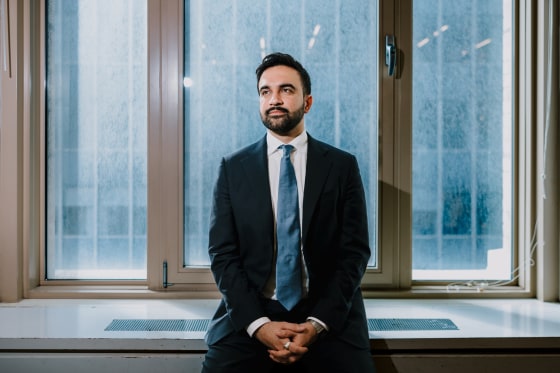 Zohran Mamdani poses on a window sill for a portrait