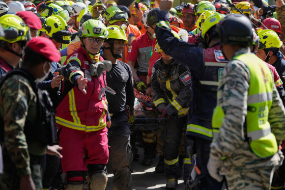 Rescue workers carry Hernán Alberto Flores Gil after he was pulled from the rubble in Venezuela's Earthquake.