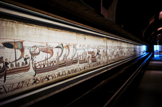 Image: Bayeux tapestry on display behind a glass case
