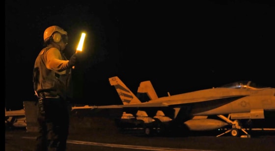 An aircraft prepares to launch as U.S. Central Command forces strike Iranian military targets in video released Sunday.