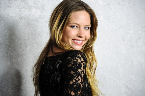 Daveigh Chase smiles while looking over her shoulder, posing for a portrait