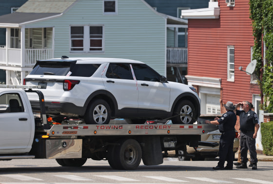Authorities tow a car from the scene of an ICE shooting on July 13, 2026, in Biddeford, Maine.