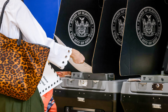 A voter scans their ballot.